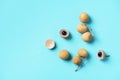 Longan fruits on blue background. Top view. Copy space. Dimocarpus longan. Bunch of exotic longans. Tropical food concept