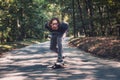 Longboard skating - Skateboarder ride a longboard through the forest