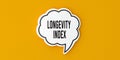 Longevity Index text on speech bubble. Yellow background. Royalty Free Stock Photo