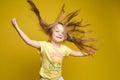 Longhaired girl in cute shirt playing with hair and twirling