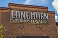 LongHorn Steakhouse sign at an angle with blue sky and clouds Royalty Free Stock Photo