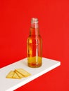 Longneck beer bottle and Cracker Biscuit isolated on red background