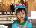 LONGNECK KAREN VILLAGE, THAILAND - DECEMBER 17. 2017: Close up portrait of young long neck girl with Thanaka face painting and