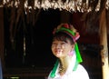 LONGNECK KAREN VILLAGE, THAILAND - DECEMBER 17. 2017: Long neck woman sitting in front of a hut