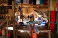 LONGNECK KAREN VILLAGE, THAILAND - DECEMBER 17. 2017: Young Long neck girl sitting lonely in a hut with thatched roof