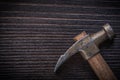 Longstanding claw hammer on vintage wooden board