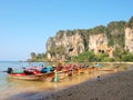 Longtail boat on the sandy beach of Koh Phangan island against the blue sky