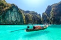 Longtail boats floating on a turquoise and clear sea. Tropical beach with white sand,Phi Phi island,Thailand Royalty Free Stock Photo