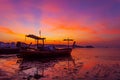 Longtail fishing boat in the sea in morning time sunrise or sunset light with beautiful sunrise and reflection in the water at Royalty Free Stock Photo