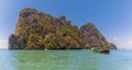 A longtailed speed boat moored of an islet in  Phang Nga Bay in Thailand Royalty Free Stock Photo