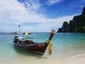 Longtale Thai taxi boat on white sand sea beach and blue sky