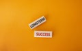 Longterm success symbol. Wooden blocks with words Longterm success. Beautiful orange background. Business and Longterm success Royalty Free Stock Photo