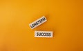 Longterm success symbol. Wooden blocks with words Longterm success. Beautiful yellow background. Business and Longterm success Royalty Free Stock Photo