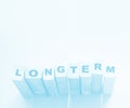 Longterm word on wooden cubes on cyan light blue background. Trustworthy business longterm relationship concept