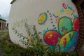 street art, with colorful graffiti on a beige wall in Longwy