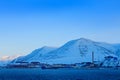 Longyearbyen, holiday travel in Arctic, Svalbard, Norway. People on the boat. Winter mountain with snow, blue glacier ice with sea