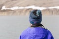 Longyearbyen, Norway, June 25 2016: Tourist with a cap taken from behind looks to the landscape Royalty Free Stock Photo