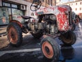 Old vintage tractor on the square at the annual agricultural fair.