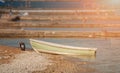 Lonley boat standing on a rocky beach on summer day Royalty Free Stock Photo