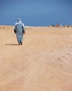 Lonley man going to his camels Royalty Free Stock Photo