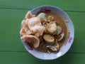 Lontong opor is a typical Indonesian food served on a white plate, the Sasa brand