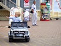 Loo Sochi, Russia, 08.31.2017: A little blond boy rides an electric car for the first time