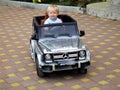 Loo Sochi, Russia, 08.31.2017: A little blond boy rides an electric car for the first time