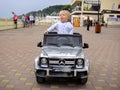 Loo Sochi, Russia, 08.31.2017: A little blond boy rides an electric car for the first time