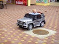 Loo Sochi, Russia, 08.31.2017: A little blond boy rides an electric car for the first time
