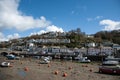 Looe harbor with low tide boats moored . Cloudy Spring day. Looe Harbor, Cornwall, UK