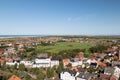 A look from above the lighthouse to the landscape of the northern sea island borkum with a green floor in the middle