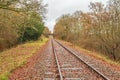 A look along the empty single line rural rail track in East Sussex England on a colourful Autumn day