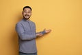 Look At This. Asian Man Pointing At Copy Space With Two Hands Royalty Free Stock Photo