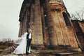 A look from below on the stunning wedding couple posing behind a