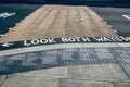 `Look both ways` road marking on a pedestrian crossing, London, UK