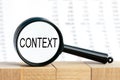 Look closely and Context with a magnifying glass , business concept image with soft focus background