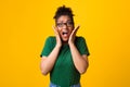 Surprised afro woman in specs screaming at studio Royalty Free Stock Photo