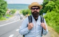 Look for fellow travelers. Tips of experienced backpacker. Man bearded hipster backpacker at edge of highway. Pick me up