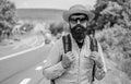 Look for fellow travelers. Tips of experienced backpacker. Man bearded hipster backpacker at edge of highway. Pick me up