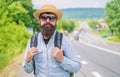 Look for fellow travelers. Tips of experienced backpacker. Man bearded hipster backpacker at edge of highway. Pick me up