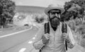 Look for fellow travelers. Tips of experienced tourist. Man bearded hipster tourist at edge of highway. Looking for Royalty Free Stock Photo