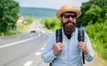 Look for fellow travelers. Tips of experienced tourist. Man bearded hipster tourist at edge of highway. Looking for Royalty Free Stock Photo