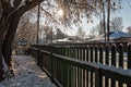 Look through the fence in the village street. A Sunny winter day.