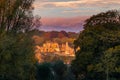 A look through in the forest with a view at the ruins in the Dutch city of Valkenburg in the golden light of the sunrise