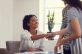 We look forward to having you. two young businesswomen shaking hands in a modern office. Royalty Free Stock Photo