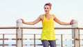 Young woman in fitness outfit looking aside at embankment Royalty Free Stock Photo