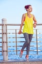 Woman in fitness outfit looking into distance at embankment Royalty Free Stock Photo