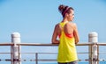 Young woman in fitness outfit looking aside at embankment Royalty Free Stock Photo