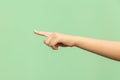 Look this! Hand finger pointing isolated on green background.