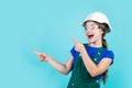 Look here. Little girl in hard hat play in workshop. Child protection and safety. Little smiling builder in helmet